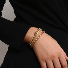 Two elegant 18K gold-plated chain bracelets featuring curb and rope designs, showcasing a stylish chain link pattern.