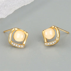 Beautiful gold-plated stud earrings with white cubic zirconia, designed in a rhombus shape for a touch of elegance.