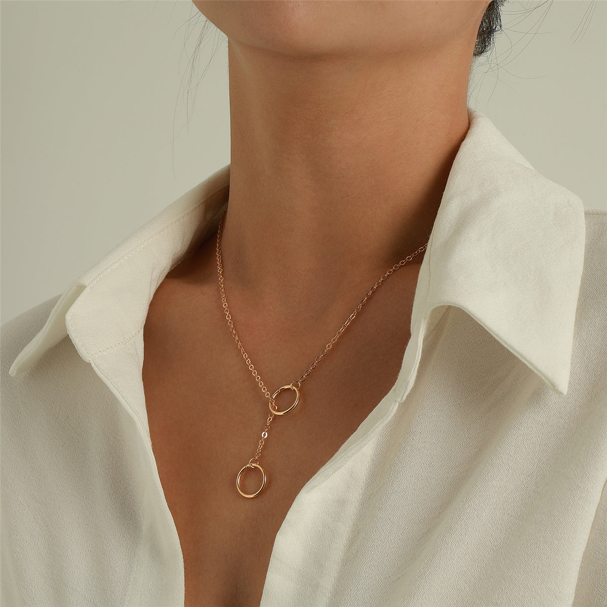 Beautiful 18K gold-plated necklace in rose gold, showcasing two circles, a chic accessory for any outfit.