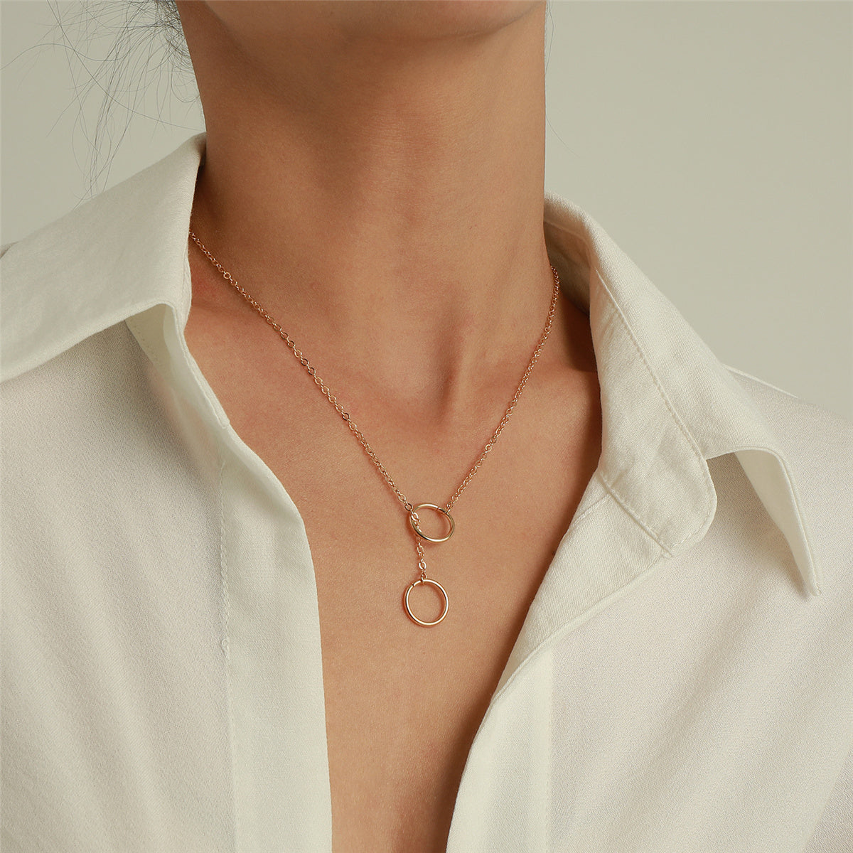 Elegant 18K gold-plated rose gold necklace featuring two intertwined circles, perfect for any occasion.